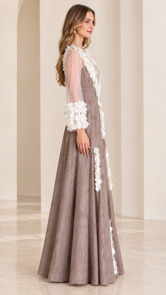 Side profile view of taupe maxi evening dress showing long sheer sleeves and flowing A-line skirt