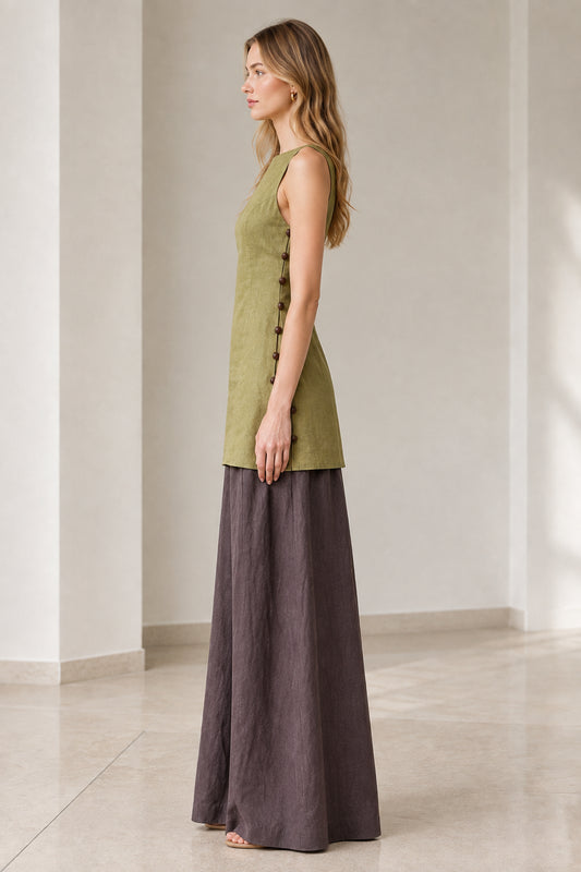 Side profile of model wearing olive green longline tunic and fluid dark wide-leg trousers