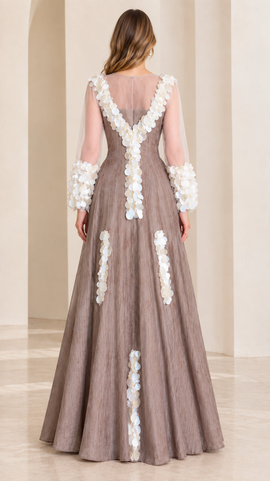 Back full-length view of taupe formal gown featuring sheer back yoke and vertical petal trims