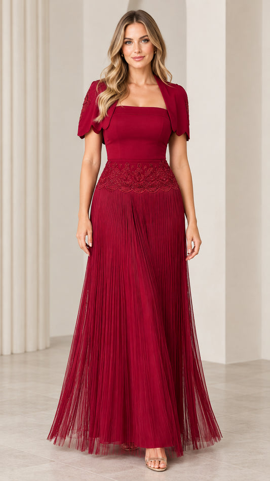 Front view of woman wearing burgundy square neck pleated maxi formal gown with embroidered bolero jacket