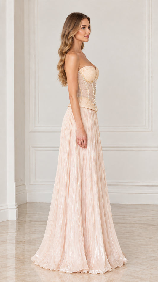 Side profile view of Champagne beaded corset formal gown with pleated skirt