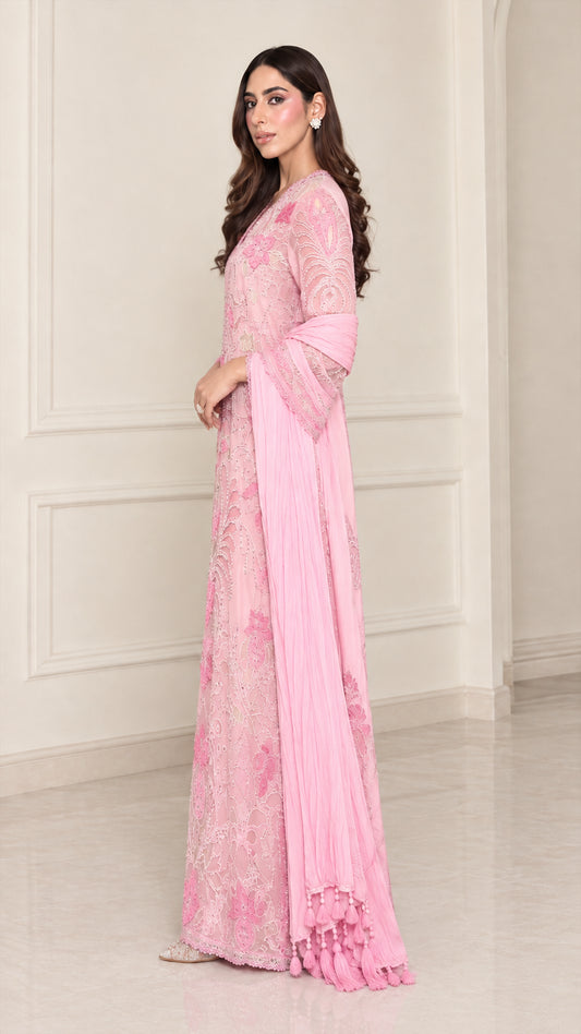 Side angle view of light pink embroidered formal evening gown