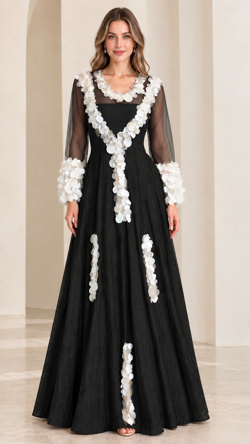 Front full-length view of black A-line evening maxi gown with contrasting white petal embellishments
