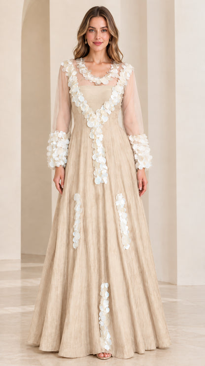 Front full-length view of champagne beige A-line evening dress with delicate white petal trim